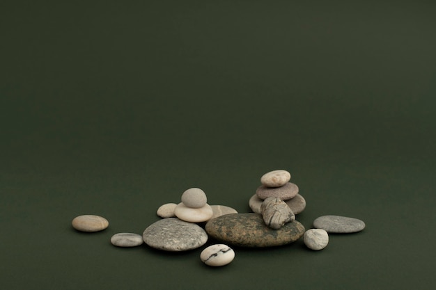 Free Photo marble zen stones stacked on green background in health and wellbeing concept