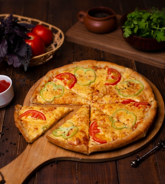 Margarita pizza with fresh parmesan cheese, red and green bell pepper slices.