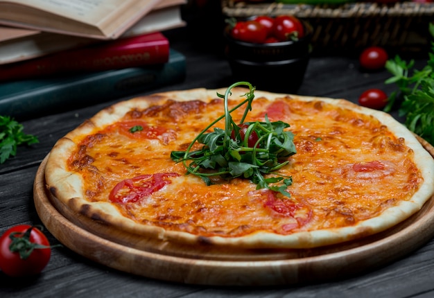 Margarita pizza with tomato sauce and mozarella cheese served with green salad