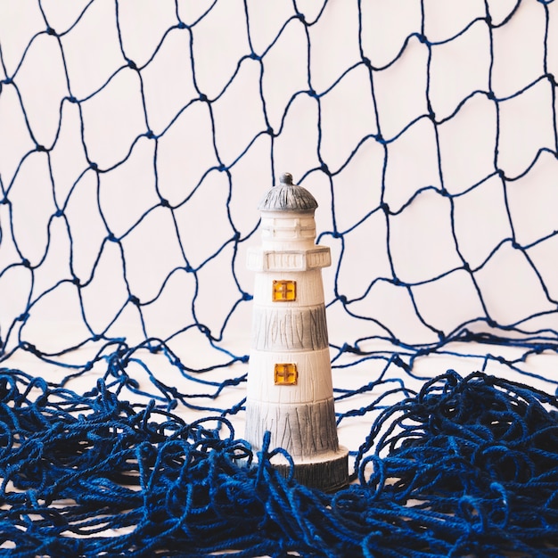 Free Photo marine composition with lighthouse and fishing net