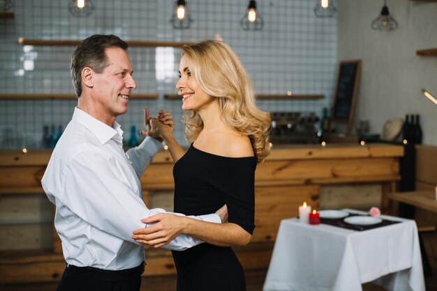 Married couple dancing during a romantic dinner