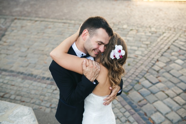 Married couple embracing on the street