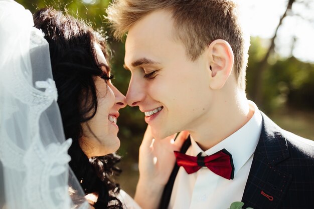 Married couple kissing in woods