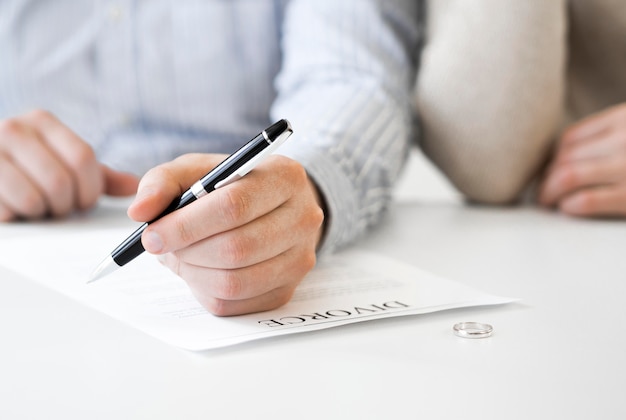 Free photo married couple signing divorce contract