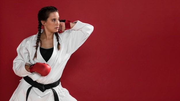 Free photo martial arts karate girl with black belt and copy space background