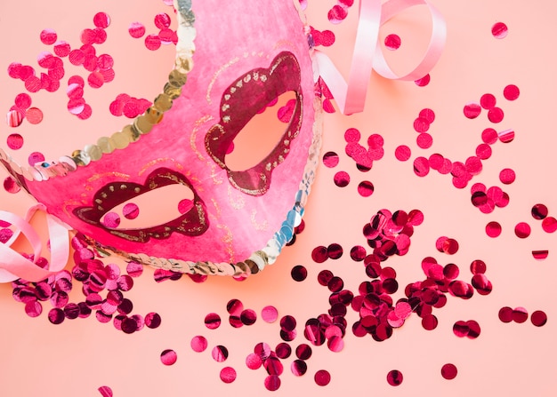 Mask near set of rose glitters