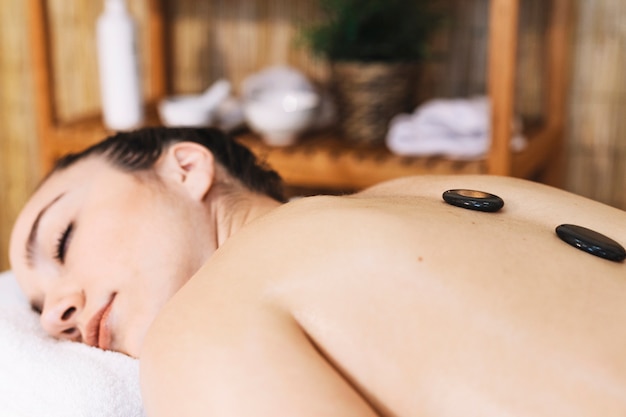 Free photo massage concept with stones on womans back