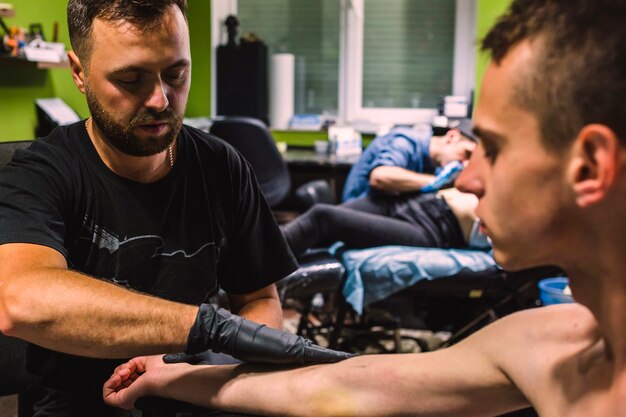 Master making tattoo in studio 