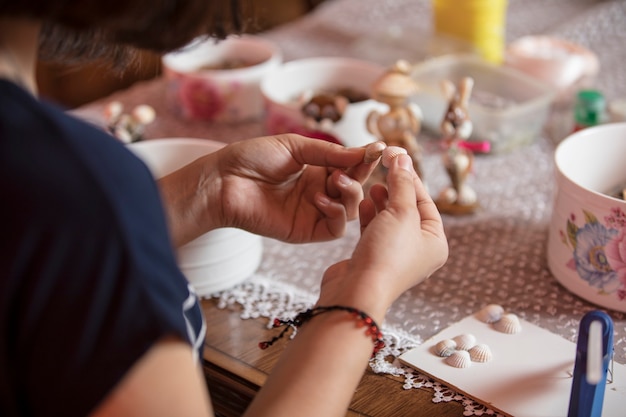 Free Photo master using small pins to make decorations.