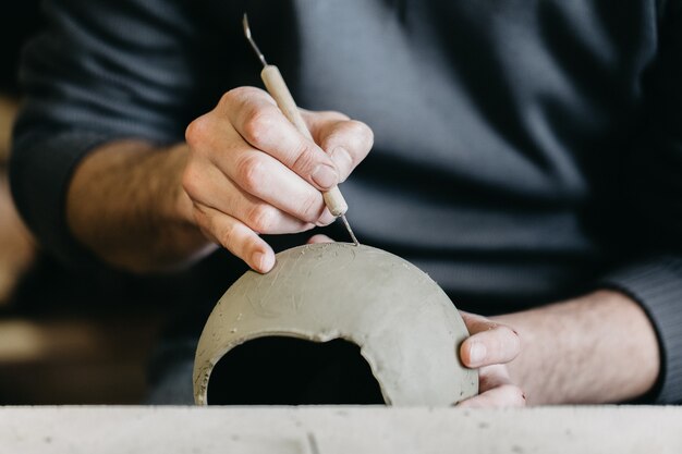 Master working on a clay sculpture model