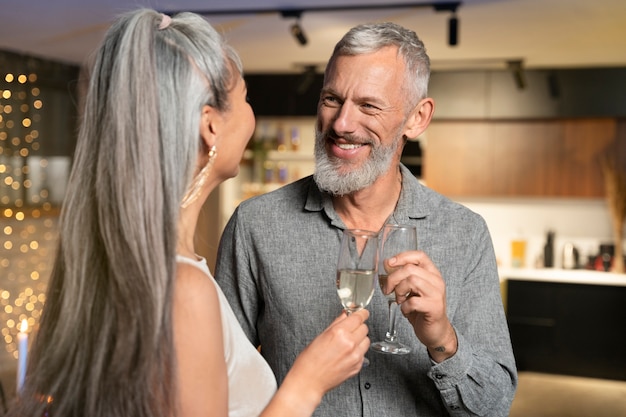 Mature couple enjoying some drinks on new year party