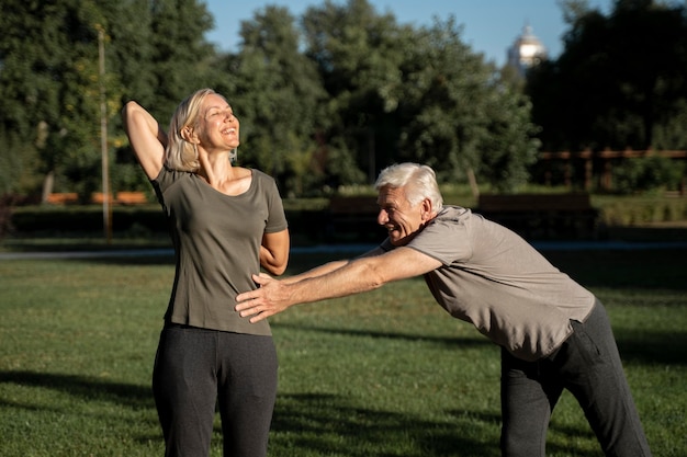 Mature couple stretching outdoors