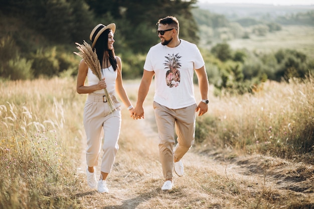 Mature couple walking together in field