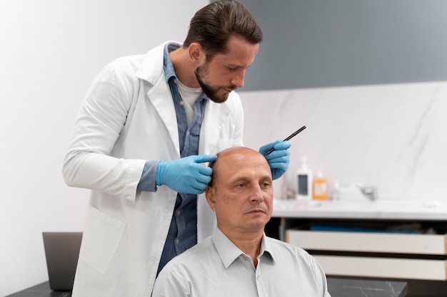 Mature man going through a follicular unit extraction process