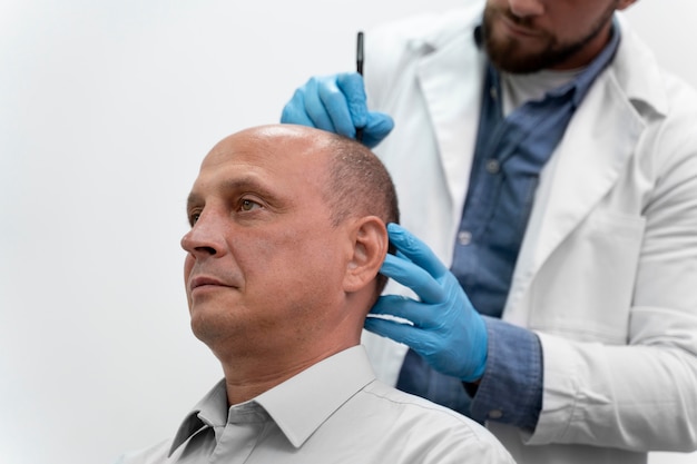 Mature man going through a follicular unit extraction process