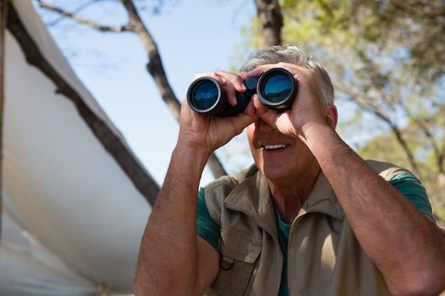 Free photo mature man looking through binocular