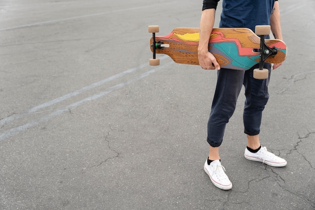 Free photo mature man with sustainable mobility skateboard