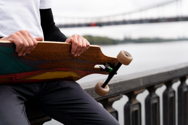 Mature man with sustainable mobility skateboard