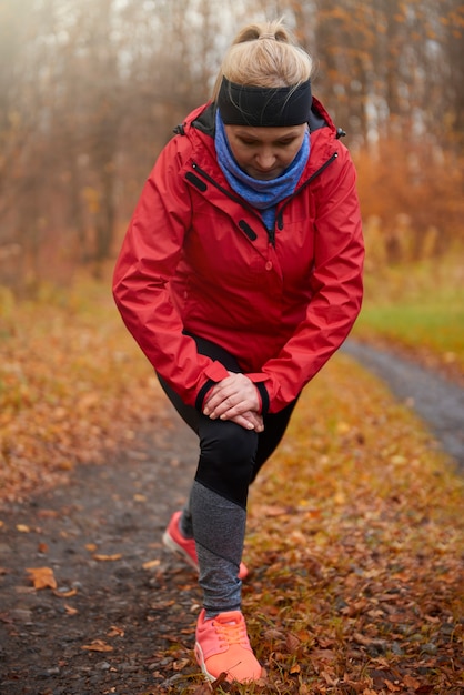 Free photo mature woman stretching before exercise