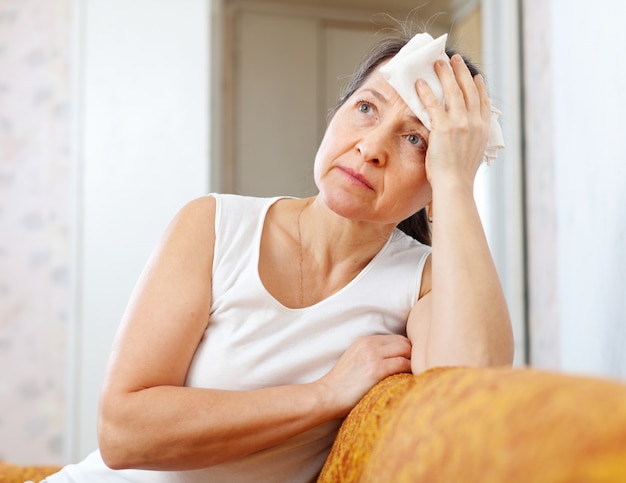 mature woman uses handkerchief on  head