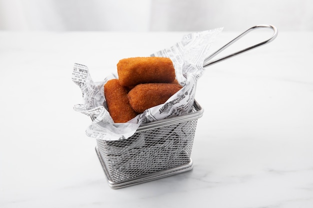 Meal containing croquettes in a small basket