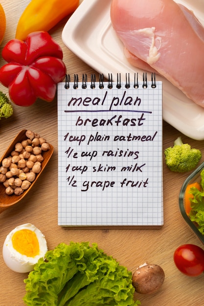 Free photo meal planning notepad and food arrangement