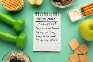 Free photo meal planning notepad and food assortment