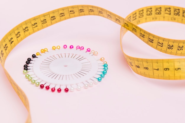 Free photo measuring tape with colorful needles