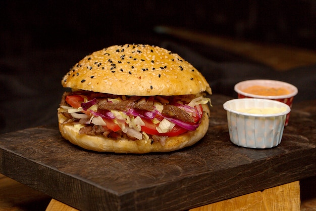 Meat doner in bread on a wooden board