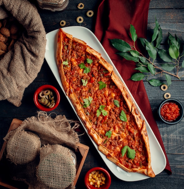 Meat pide with green on the table