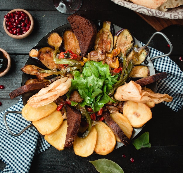 meat potato vegetables cooked on charcoal