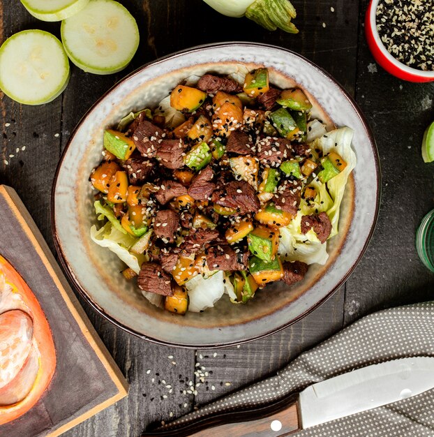 Meat salad with vegetables and green