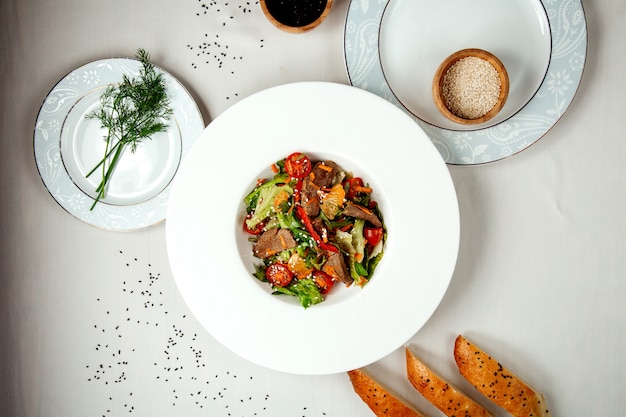 Meat salad with vegetables on the table