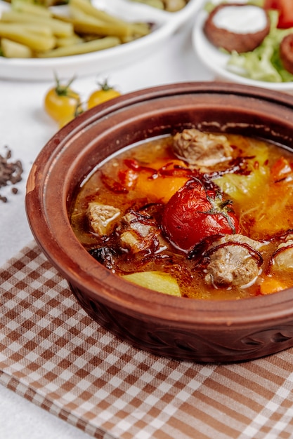 Free Photo meat with potatoes and tomatoes in a clay pot