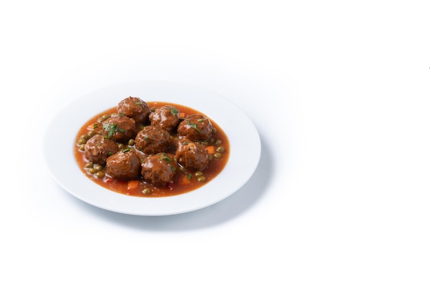 Meatballs green peas and carrot with tomato sauce isolated on white background