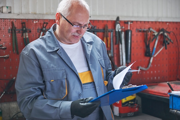 Mechanic checking a car report