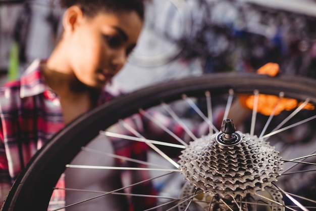 Free photo mechanic examining a bicycle wheel