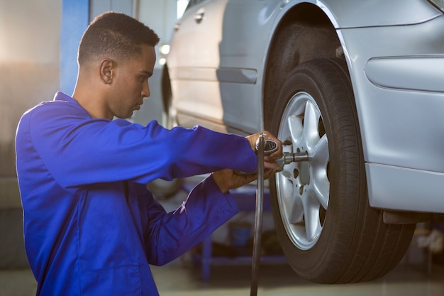 Mechanic fixing a car tyre