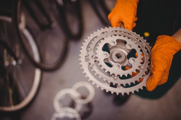 Mechanic holding a bicycle gear