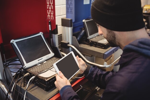 Mechanic holding digital tablet