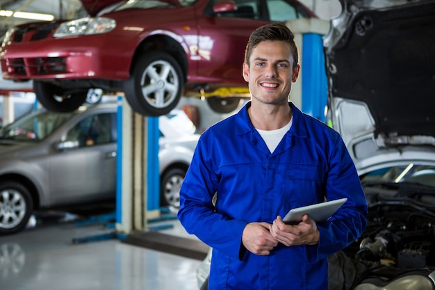 Mechanic holding digital tablet