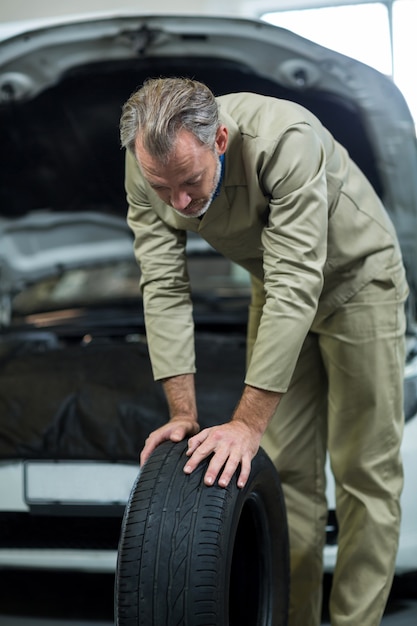 Mechanic looking at tyre