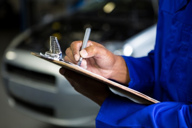 Mechanic preparing a check list