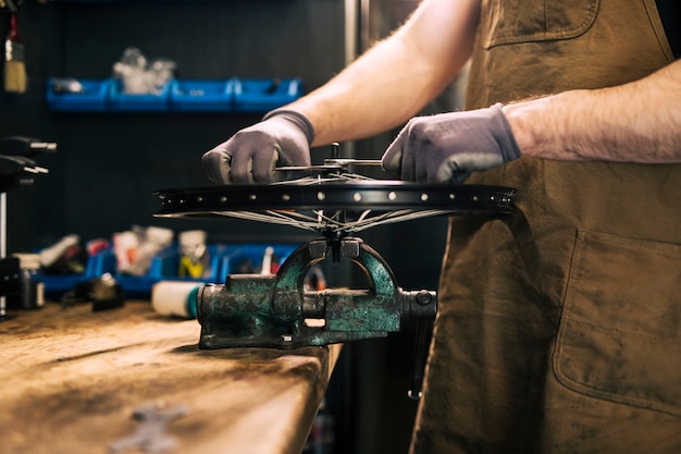 Free photo mechanic repairing a bicycle