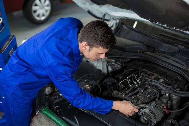 Mechanic servicing a car engine