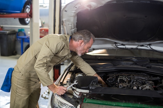 Mechanic servicing a car engine