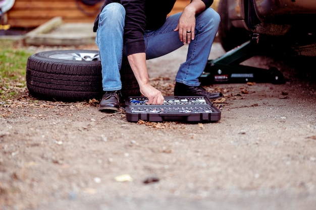 Free photo mechanic with tools repairing a car