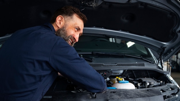 Free photo mechanic working on  a car