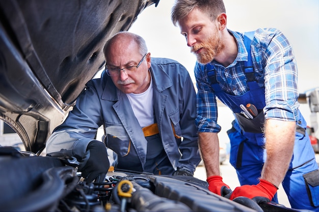 Mechanics repairing a car in the workshop