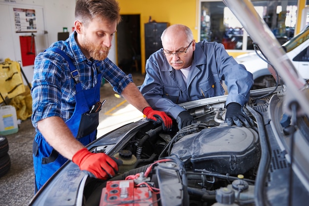 Free Photo mechanics repairing a car in the workshop